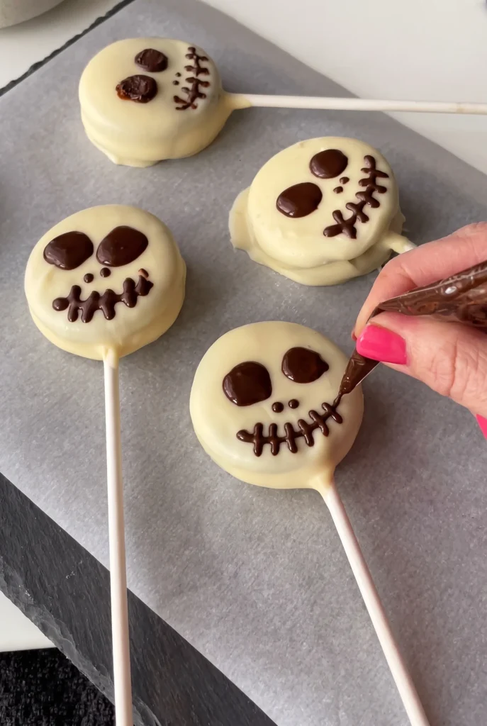 Easy Halloween Skeleton Oreo Pops on a dessert table